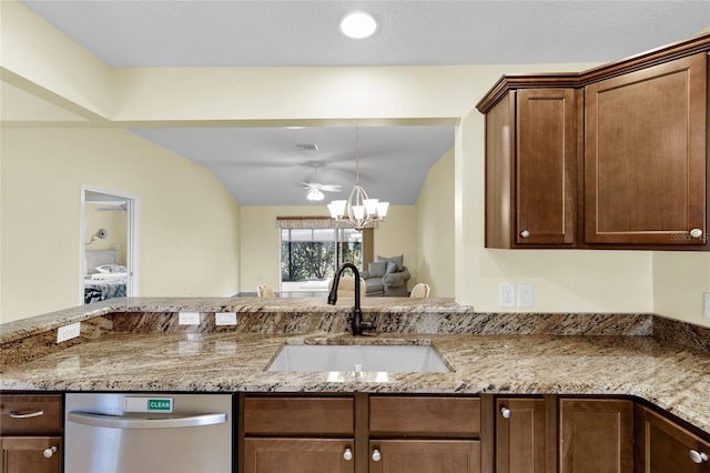 kitchen featuring sink, stainless steel dishwasher, vaulted ceiling, and an inviting chandelier