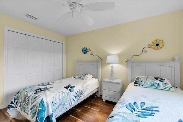 bedroom with a closet, ceiling fan, and dark wood-type flooring