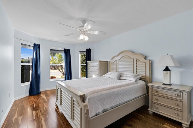 bedroom with dark hardwood / wood-style floors and ceiling fan