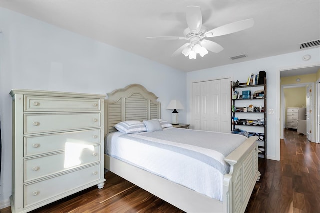 bedroom with a closet, dark hardwood / wood-style floors, and ceiling fan