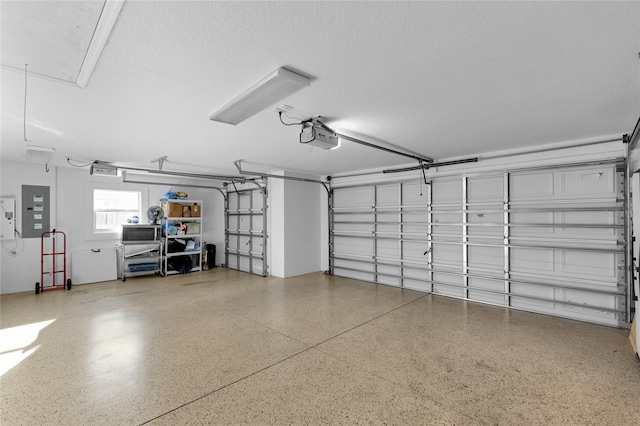 garage with electric panel and a garage door opener