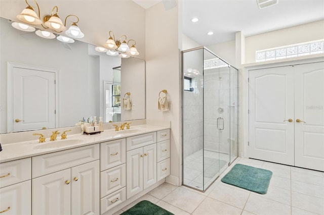 bathroom featuring tile patterned flooring, a healthy amount of sunlight, a shower with shower door, and a notable chandelier