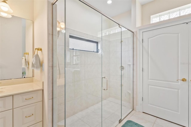 bathroom featuring tile patterned floors, vanity, and walk in shower