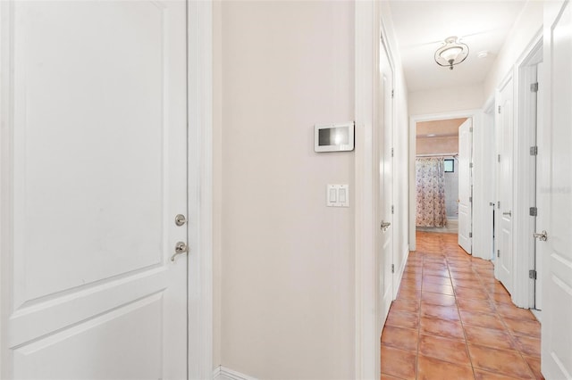 hall with light tile patterned flooring