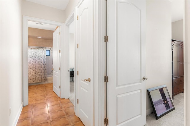 hall with light tile patterned flooring