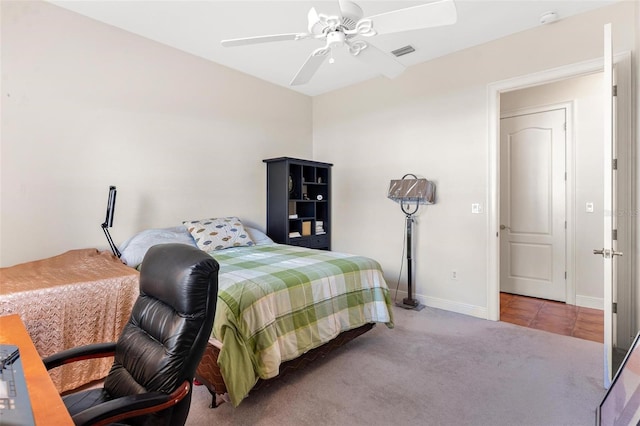 bedroom with ceiling fan and light carpet