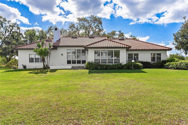 rear view of property featuring a yard