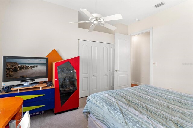 bedroom featuring light carpet, a closet, and ceiling fan