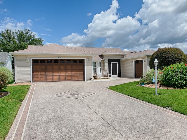 ranch-style home with a garage and a front lawn