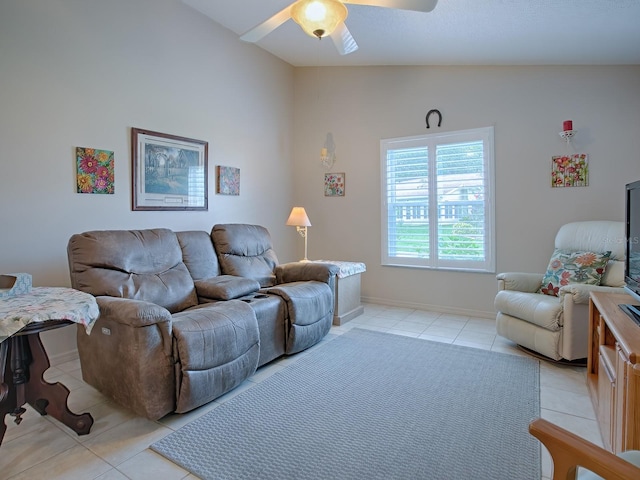 living room with ceiling fan, light tile patterned floors, and lofted ceiling