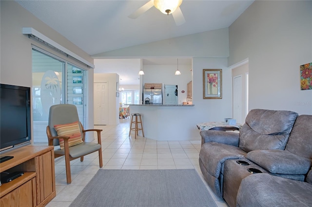 living room with ceiling fan, light tile patterned floors, and vaulted ceiling