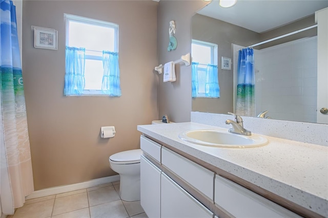 bathroom featuring tile patterned floors, a wealth of natural light, vanity, and walk in shower