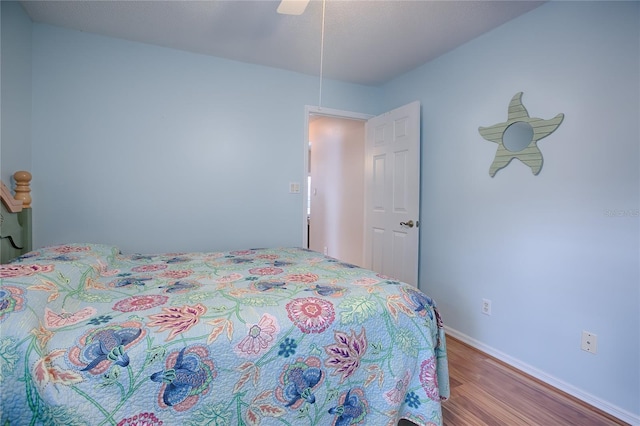 bedroom with ceiling fan and light hardwood / wood-style flooring