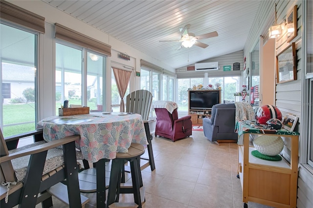 sunroom featuring an AC wall unit, a wealth of natural light, lofted ceiling, and ceiling fan