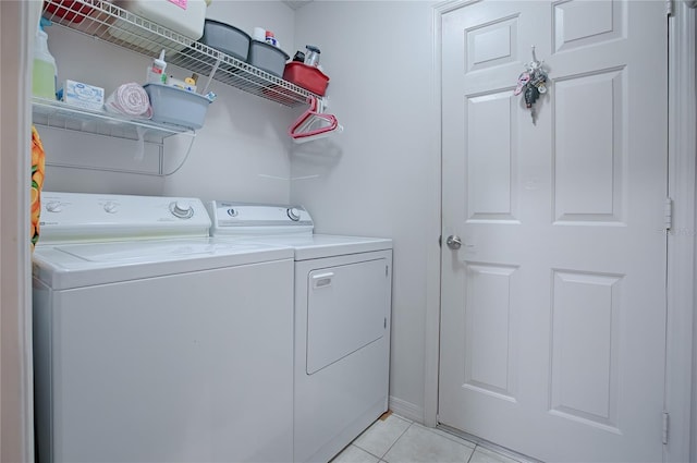 washroom with washing machine and clothes dryer and light tile patterned flooring