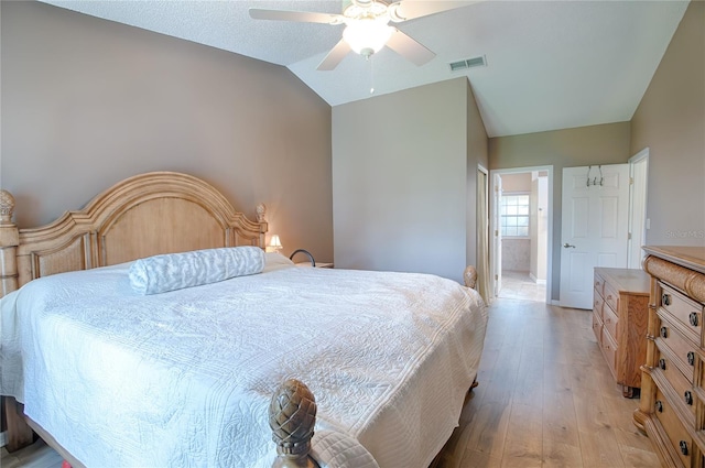 bedroom with light wood-type flooring, ceiling fan, and lofted ceiling