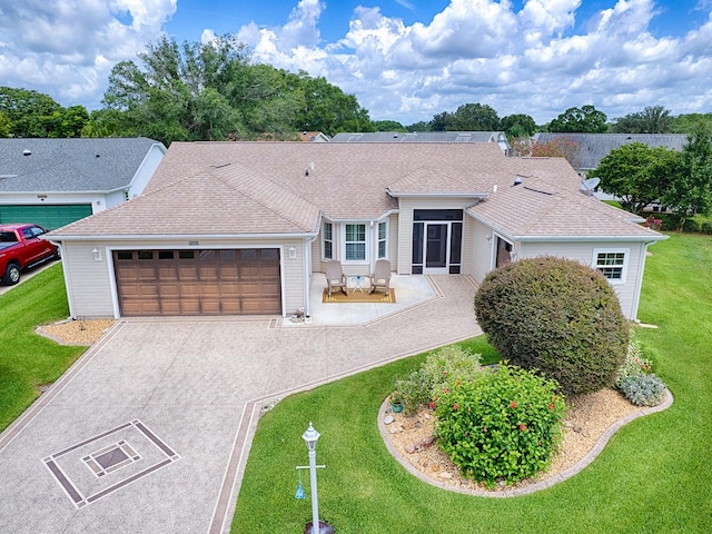 ranch-style house featuring a front yard and a garage