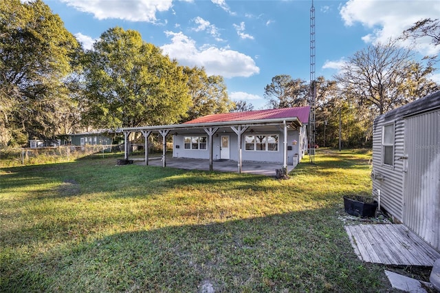 10285 NE 218th Lane Rd, Fort Mc Coy, FL 32134 - rear view of house featuring a patio, metal roof, and a lawn