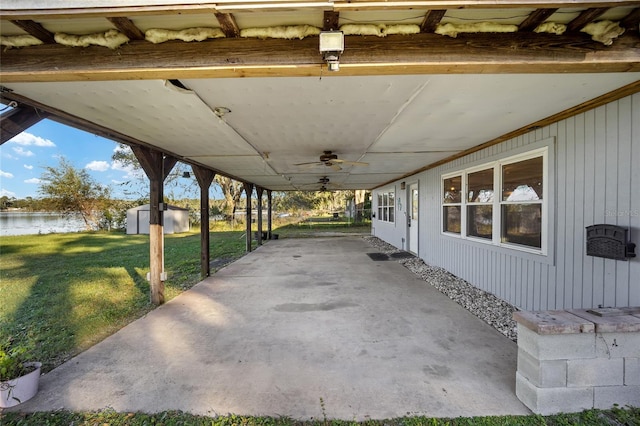 view of patio featuring ceiling fan and a storage shed