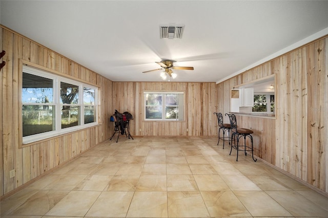 10285 NE 218th Lane Rd, Fort Mc Coy, FL 32134 - dining area with wooden walls, ceiling fan, plenty of natural light, and baseboards