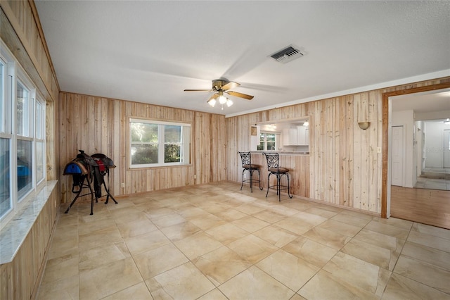 10285 NE 218th Lane Rd, Fort Mc Coy, FL 32134 - interior space featuring wooden walls, a ceiling fan, and baseboards