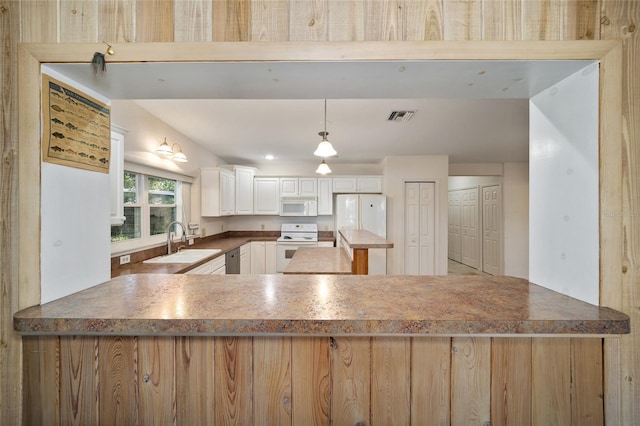 10285 NE 218th Lane Rd, Fort Mc Coy, FL 32134 - kitchen with white appliances, a sink, a peninsula, and white cabinetry