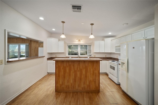 kitchen with pendant lighting, light hardwood / wood-style floors, white cabinets, and white appliances