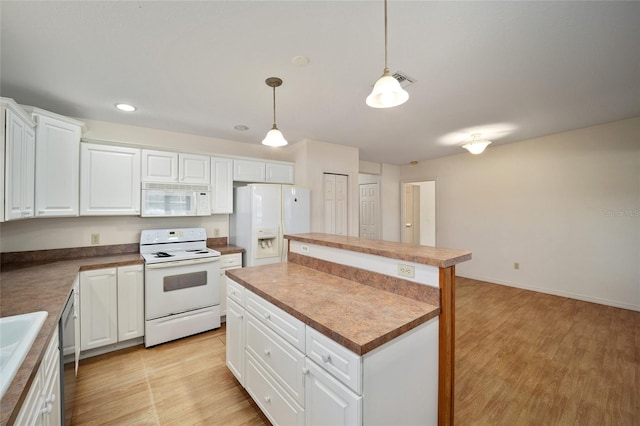 kitchen with a kitchen island, decorative light fixtures, white appliances, white cabinets, and light wood-type flooring