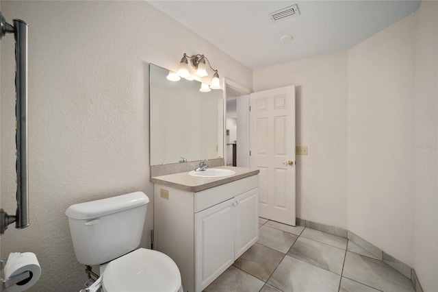 bathroom featuring tile patterned floors, vanity, and toilet