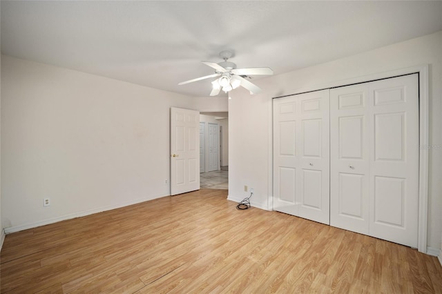 unfurnished bedroom featuring a closet, light hardwood / wood-style flooring, and ceiling fan