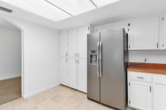 kitchen with white cabinets and stainless steel refrigerator with ice dispenser