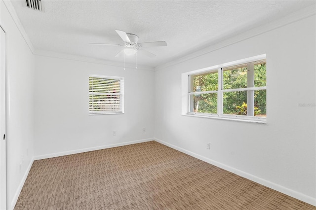 carpeted empty room with crown molding, ceiling fan, and a textured ceiling