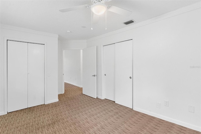 unfurnished bedroom with ceiling fan, light colored carpet, and ornamental molding