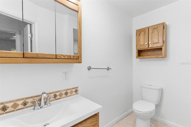 bathroom featuring toilet, vanity, and tile patterned floors