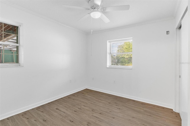 unfurnished room with hardwood / wood-style flooring, ceiling fan, and ornamental molding