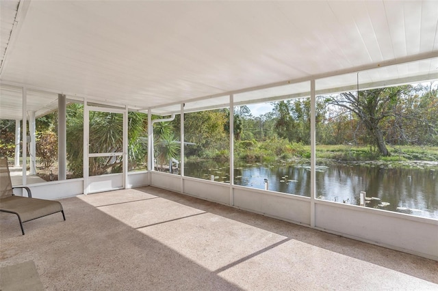 unfurnished sunroom with a water view