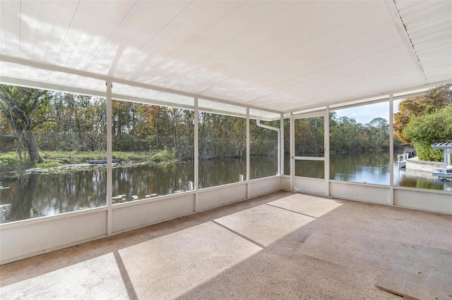 unfurnished sunroom with a water view