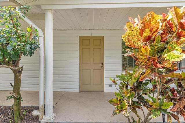 view of exterior entry with a porch