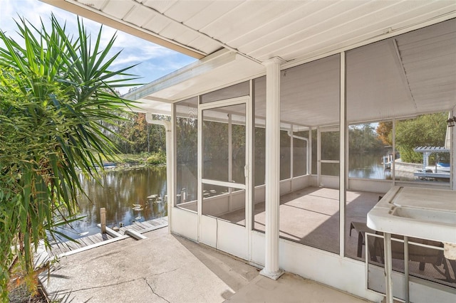 exterior space with a water view and a sunroom