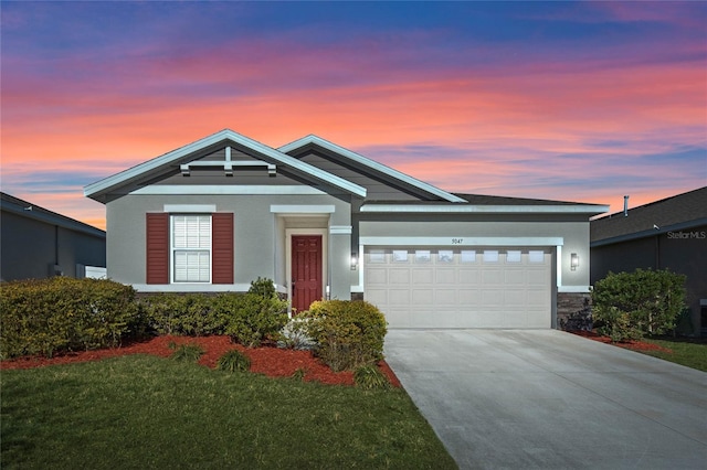 view of front of property with a yard and a garage