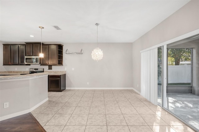 kitchen featuring a chandelier, appliances with stainless steel finishes, dark brown cabinets, and pendant lighting