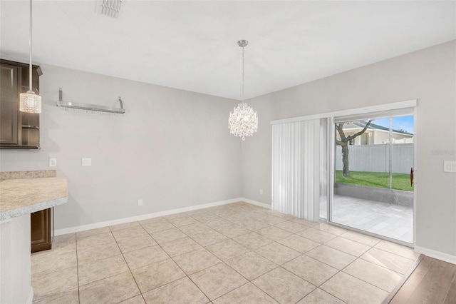 unfurnished dining area featuring light hardwood / wood-style floors and a chandelier