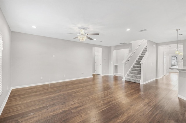 unfurnished living room with ceiling fan and dark hardwood / wood-style flooring