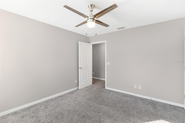 empty room with ceiling fan and carpet floors