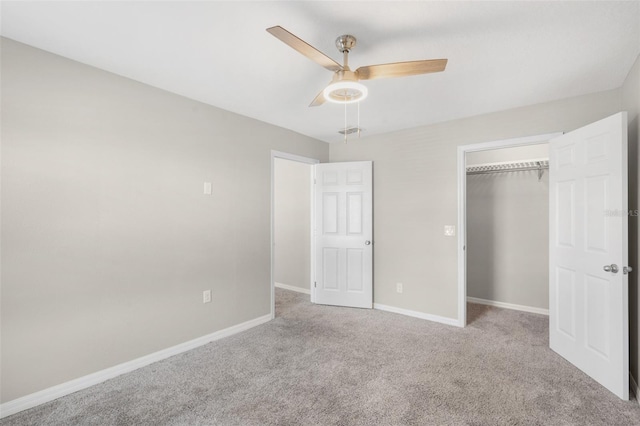 unfurnished bedroom featuring light carpet, a closet, and ceiling fan