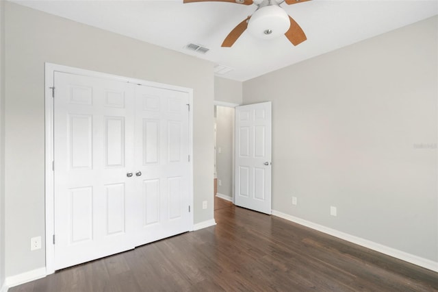 unfurnished bedroom with ceiling fan, dark hardwood / wood-style floors, and a closet