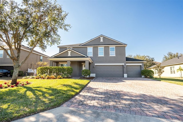 view of front of home with a front yard and a garage