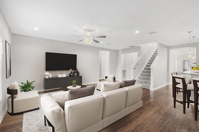 living room featuring ceiling fan and dark hardwood / wood-style flooring