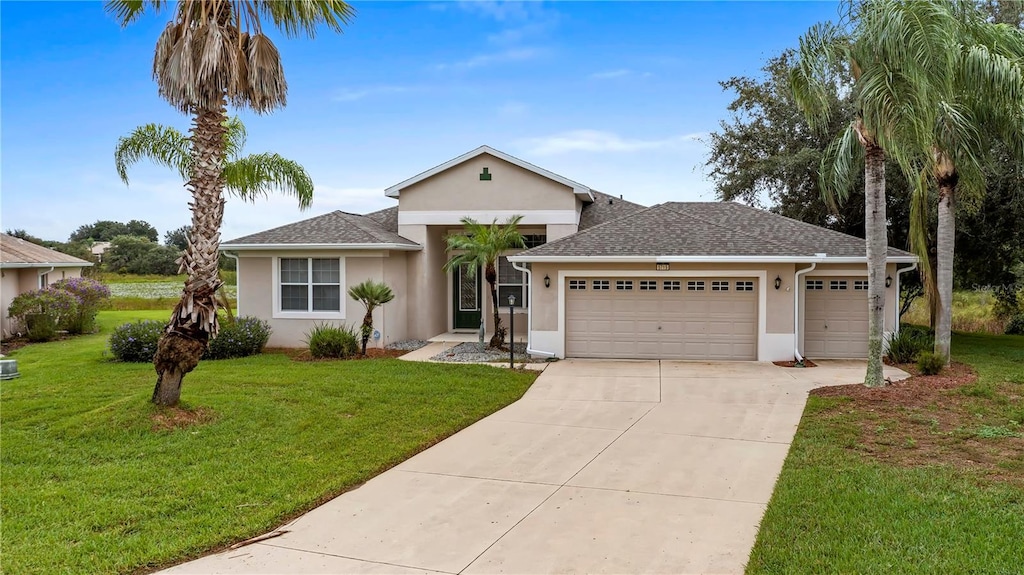 ranch-style home with a front lawn and a garage