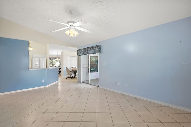 tiled spare room featuring vaulted ceiling, a textured ceiling, and ceiling fan with notable chandelier